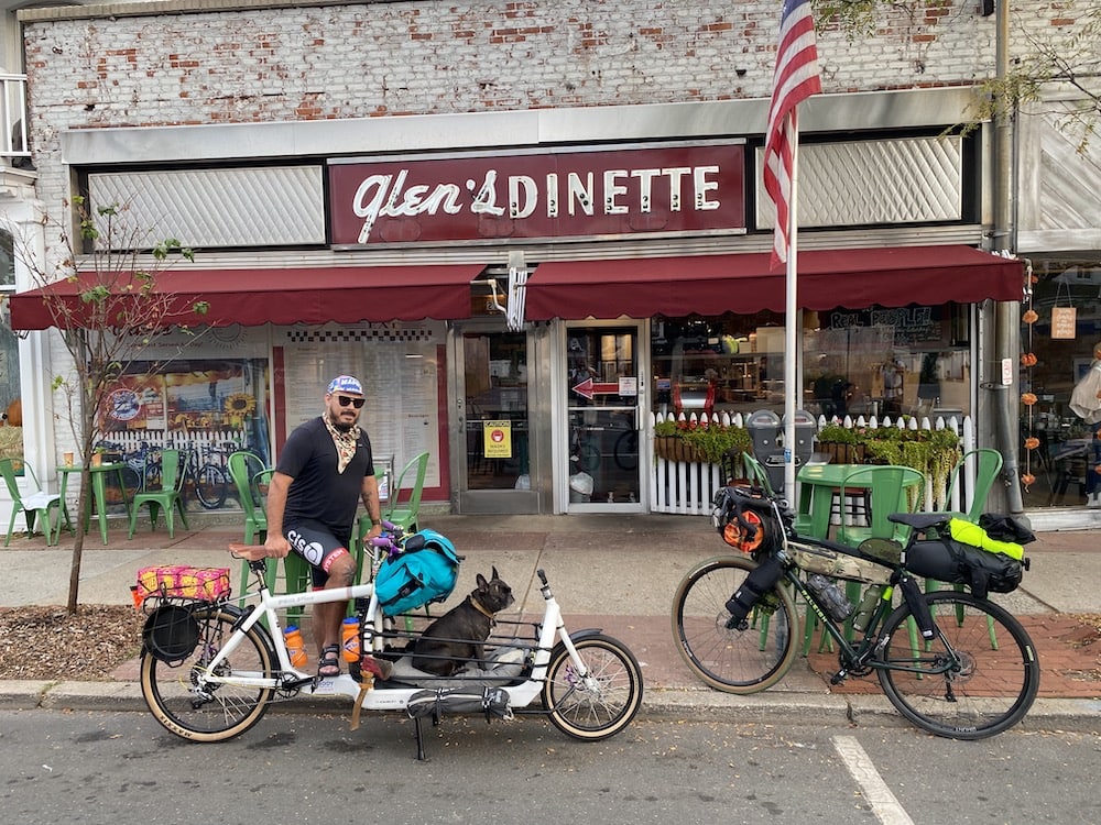 Bikepacker stands in front of Glen's Dinette